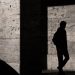 Silhouette on the wall of a man walking.