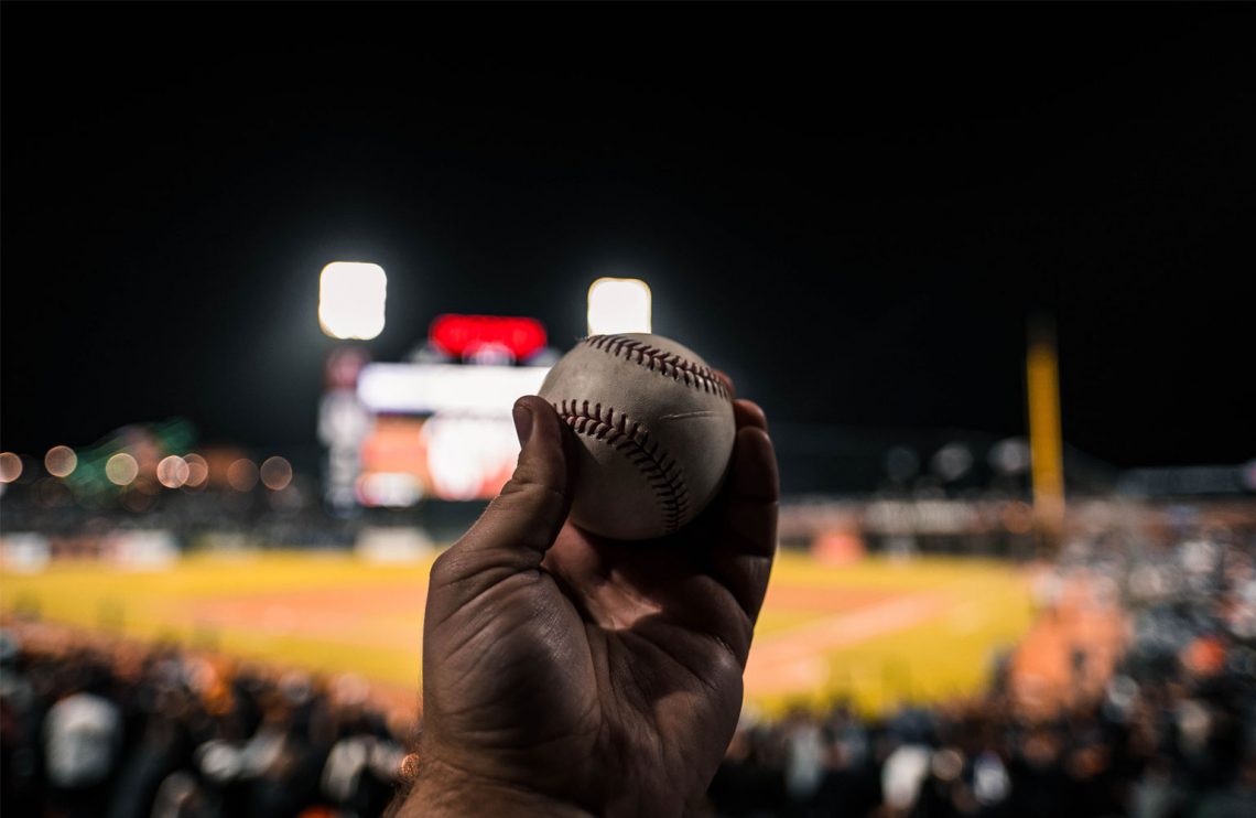 Man holding baseball in his hand.
