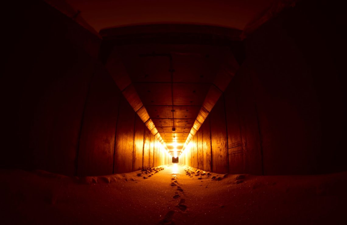 Long dark corridor with light at the end of the tunnel.