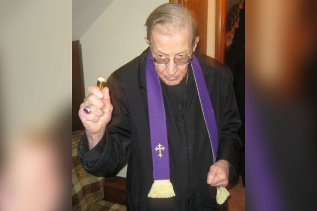 Robert McKenna using holy water.