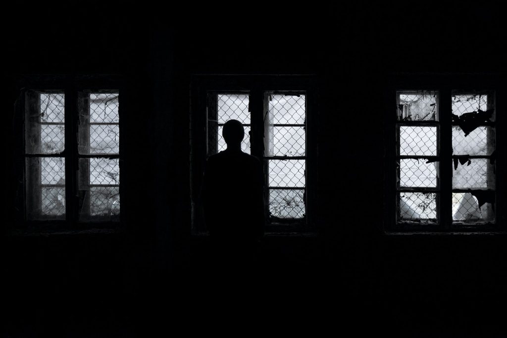 Silhouette of a man in an abandoned house.