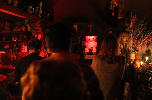 A crowd of people look on at the haunted Annabelle doll.