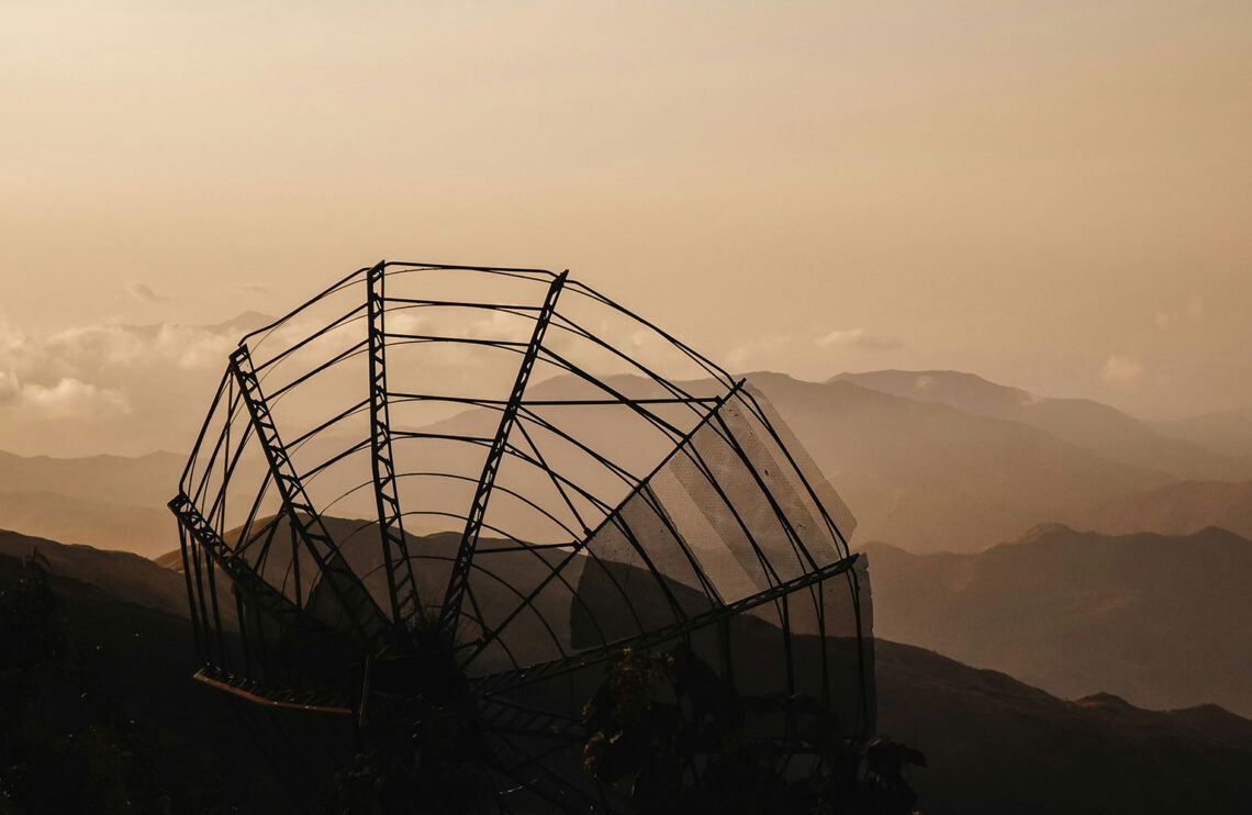 Radio telescope sitting atop a hill.